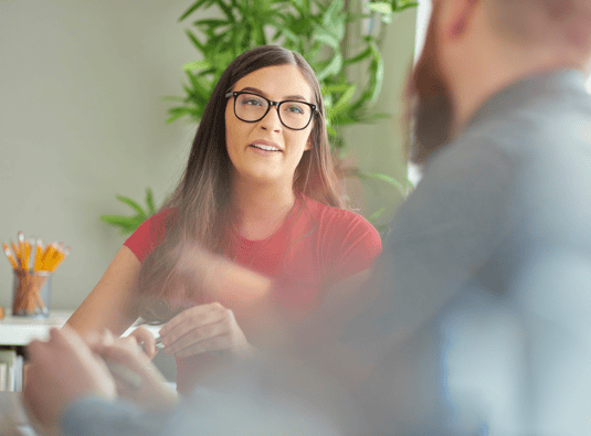 A woman listening to a man talking